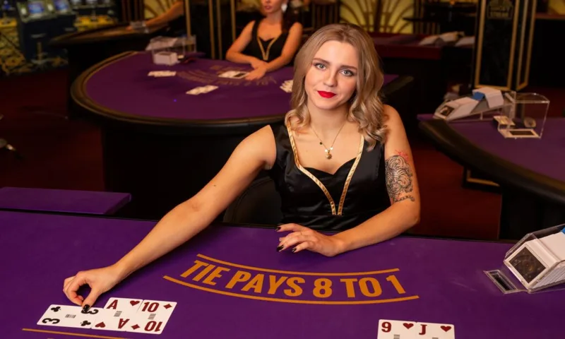 Live dealer baccarat table showing Player, Banker, and Tie betting boxes